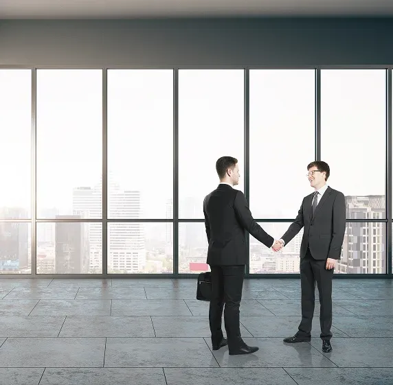 Picture of two business men meeting in an a office.